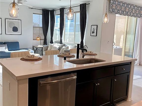 view from kitchen area of living room and backyard sliding door