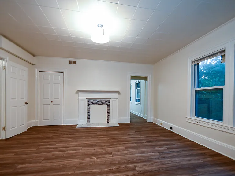 Huge living room with decorative fireplace.