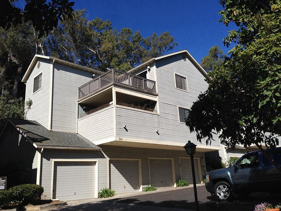 Quiet complex backs up to a hillside with Eucalyptus trees