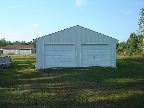 Dad will love this 32x24 pole barn with cement floor and 2 double size garage doors.  There is space enough for vehicles, lawn mower, bikes, tools, and toys.