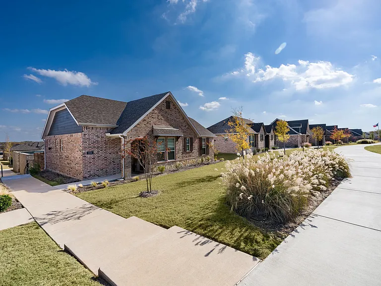 A welcoming streetscape with landscaped sidewalks and detached homes designed for everyday comfort, privacy, and a connected neighborhood setting.