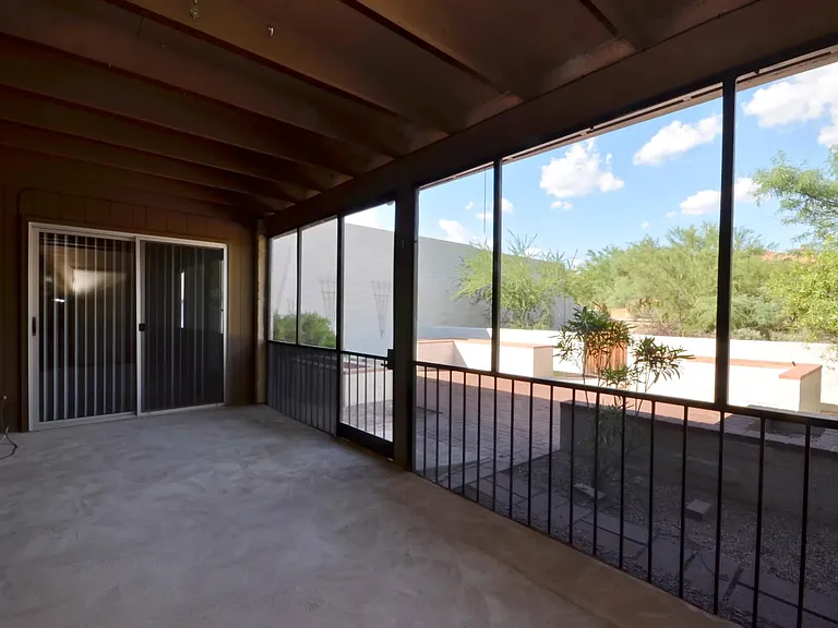 Screened in Arizona room with view to private back patio and open green space on two sides.