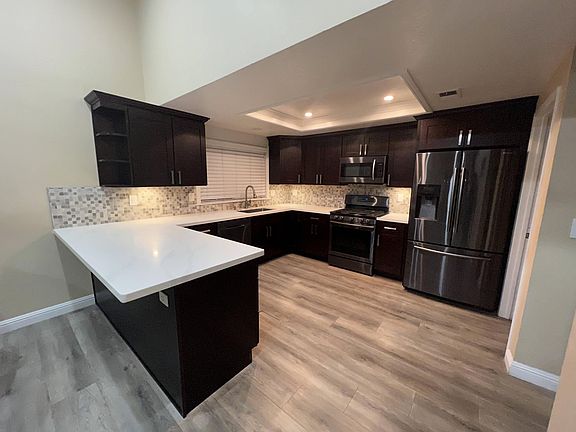 Kitchen - White Calcutta Counter Tops with all Samsung brand - stainless steel appliances