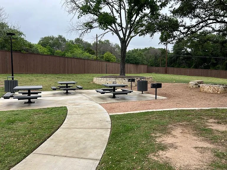 Neighborhood park one block from the townhome. The park is maintained by the neighborhood, includes doggie bags, picnic tables, large shade trees, and beautiful landscaping