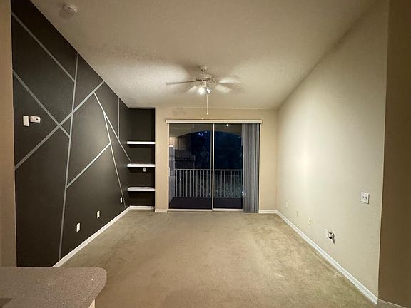 Dining area and doorway and view of balcony_. Present clean look of apartment with prior tenant having just moved out.