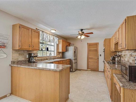 Kitchen with bar and door to utility room/laundry