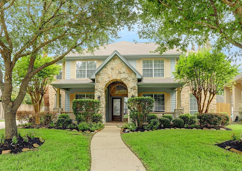 Home front view features well-established landscaping.