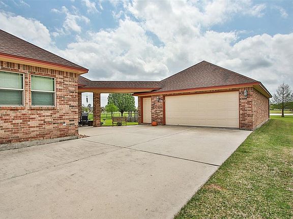 The four car garage offers plenty of space for a work shop and your vehicles. There's even attic storage here.