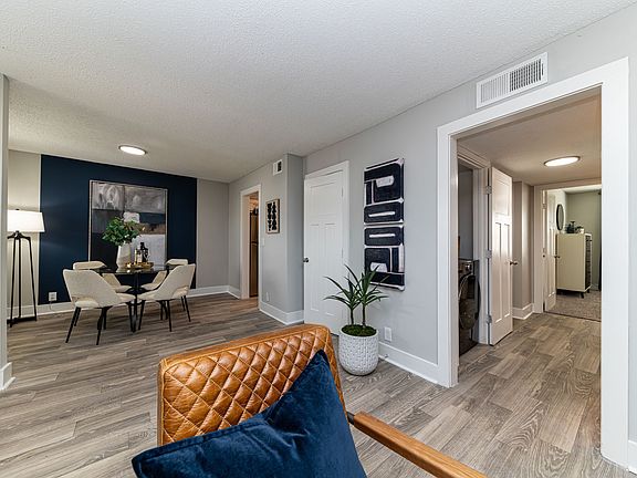 Hardwood-style flooring in living room and dining area