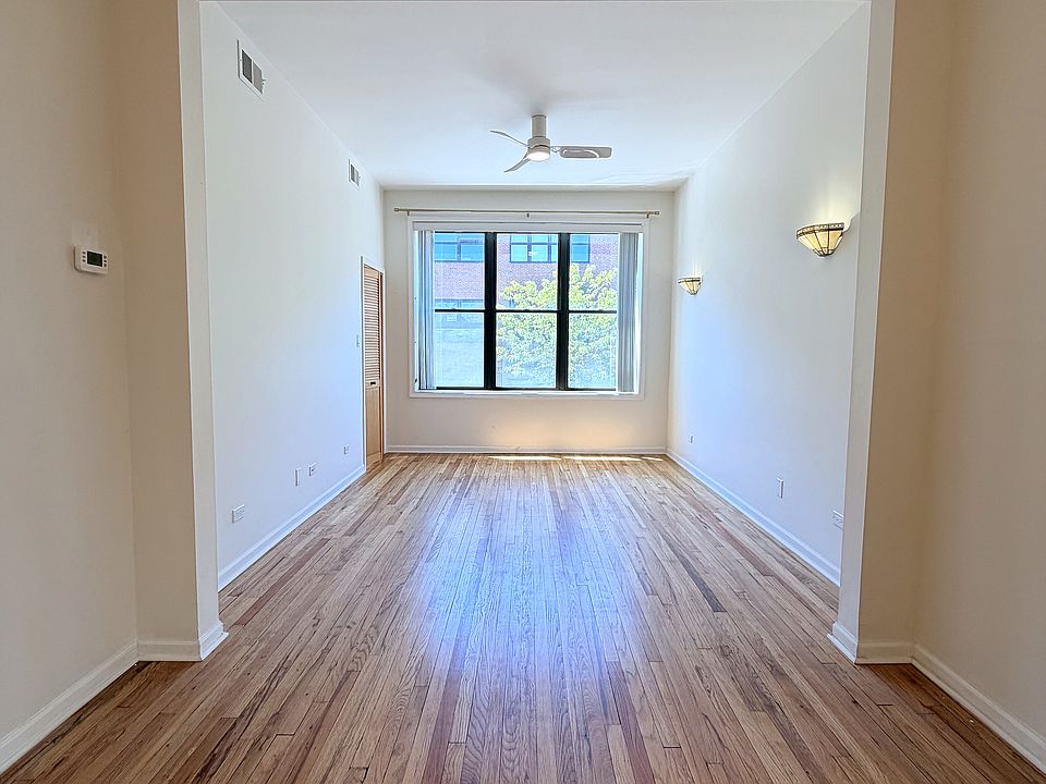 Living Room

Hardwood floors, coffered ceiling detail, and a dramatic arched entry _ the kind of character you don't find in new construction.

Real room to live. The living and dining spaces together stretch nearly the full length of the apartment.