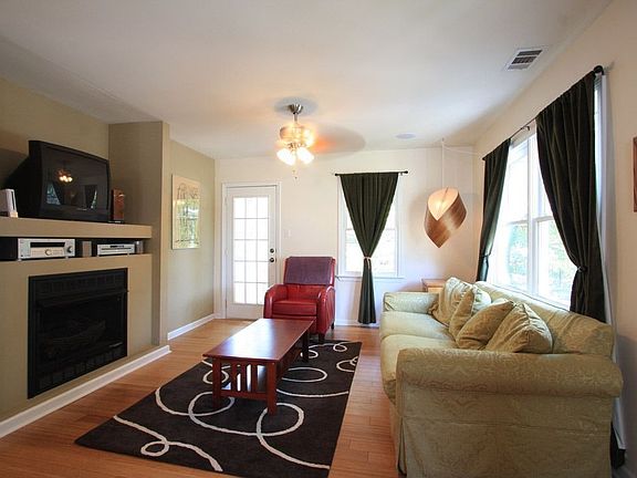 Spacious living room is centered around the fireplace.
