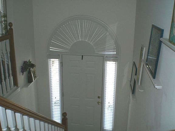 2 story foyer has hardwood floors & custom blinds