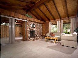 Vaulted ceilings, single level w/wood beams & cozy fireplace.