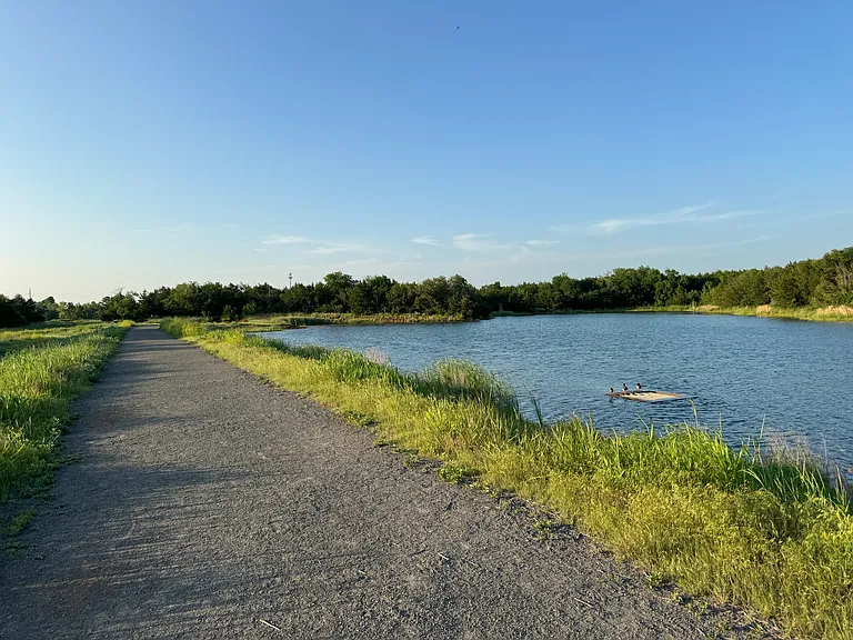 Pond and trail in wilderness area next to neighborhood