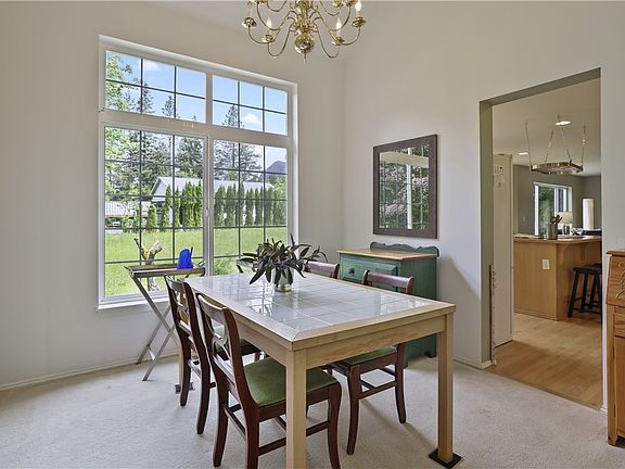 The formal dining room is right off the kitchen for easy access when entertaining and is also open to the living room. This is a great space for friends and family to gather. Look out the window and soak in the view of Mount Si!