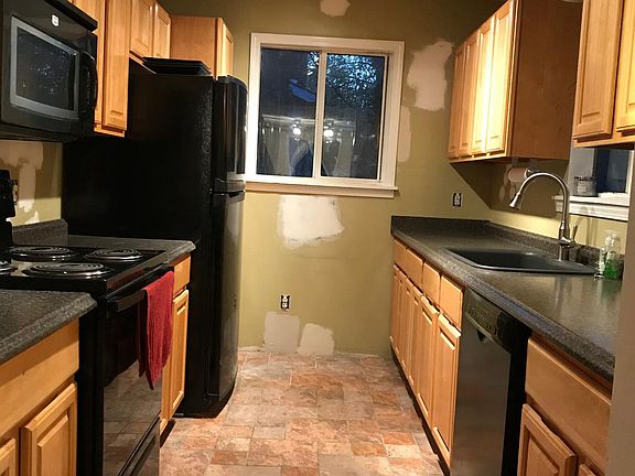 Galley kitchen with lots of counter space and cabinets.