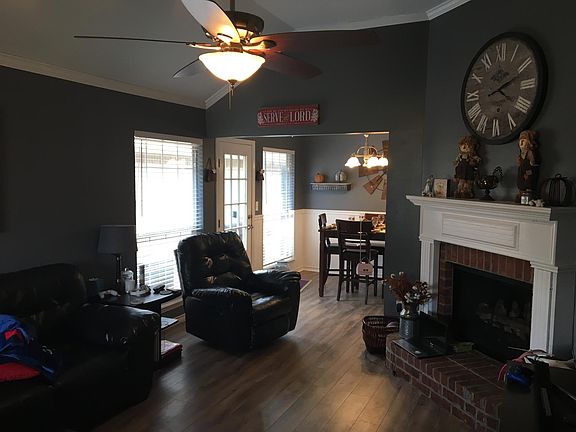 Living room with corner fireplace and vinyl plank flooring