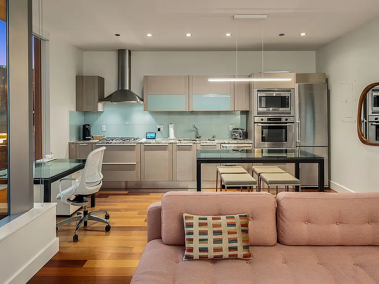 Open plan kitchen with elevated R&B dining table that doubles as an island.