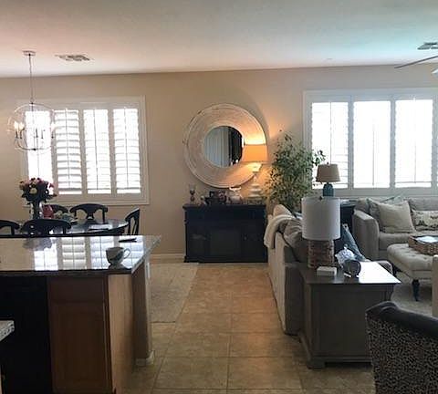 Kitchen on the left, dining room behind kitchen and family room to right