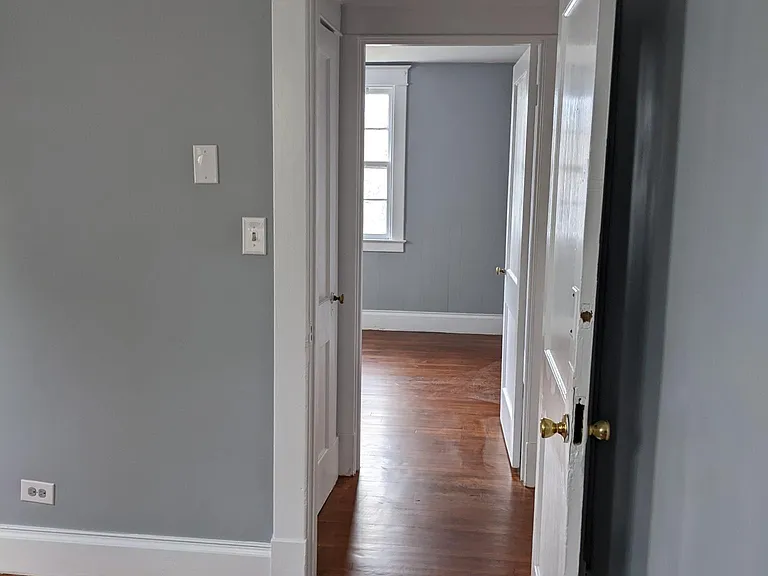 Standing in bedroom 2 (back of house) looking through doorways to bedroom 1 (front of house)