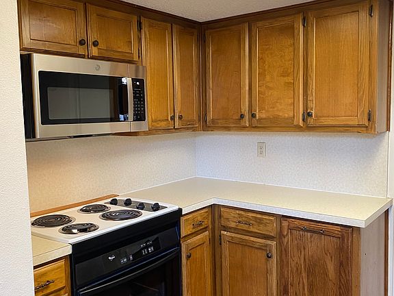 Kitchen has lots of work space for two cooks and all appliances. Just beyond the kitchen is a laundry room leading to a single car garage.