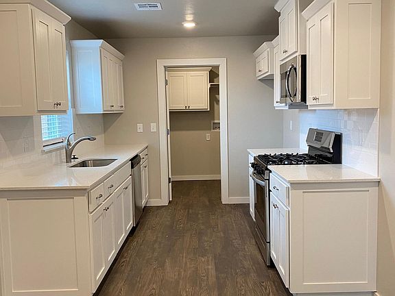 Quartz countertops, gas stove, deep stainless steel sink. Washer/Dryer and Refrigerator will be installed upon move in.