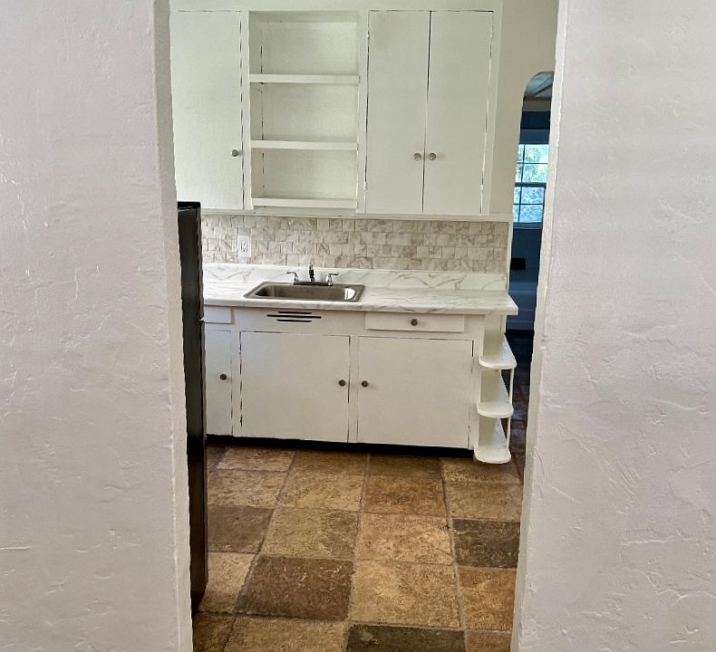 Doorway from living room into kitchen and back of the house.