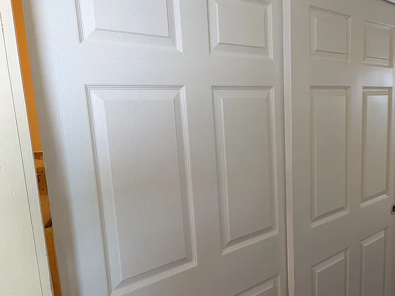 Separate laundry and utility room hidden by attractive sliding doors.