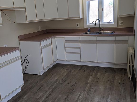 Kitchen with new flooring and faucet. Appliances will be provided.