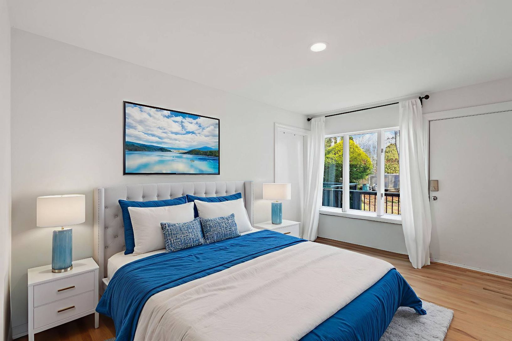 Guest Bedroom 1 of 5 featuring oak floors and recessed lighting