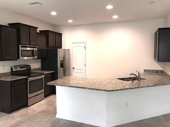 Gorgeous kitchen with brand new un-used stainless steel appliances, large granite counter-tops, nice cabinets and plenty of space in the built-in pantry