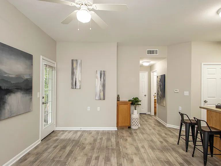 Step into our inviting living spaces with the allure of a French door beckoning you to an intimate outdoor patio.