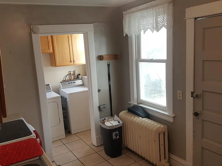 Kitchen with view of laundry room & back door to enclosed porch.