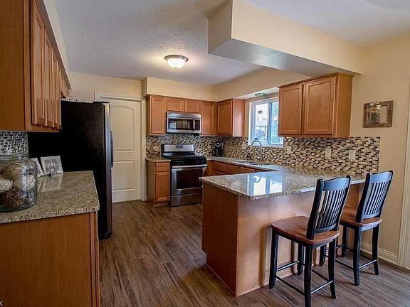 The updated Kitchen is spacious and open to the Dining area, including a convenient Breakfast Bar.