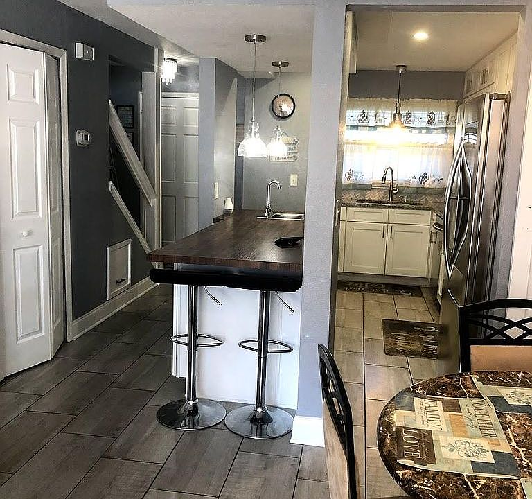 view of kitchen, entry way and laundry closet