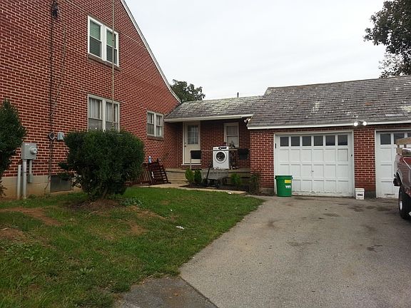 Side entrance and two car garage and workshop area.