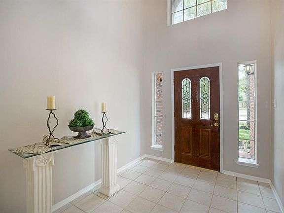 Tiled entry with 2 story ceiling.