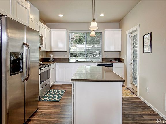 Notice the door at the end of the kitchen that leads to your own private deck AND the huge picture window that looks out over the back yard.