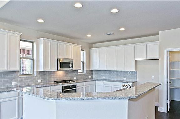 White Kitchen Cabinets and Light Island