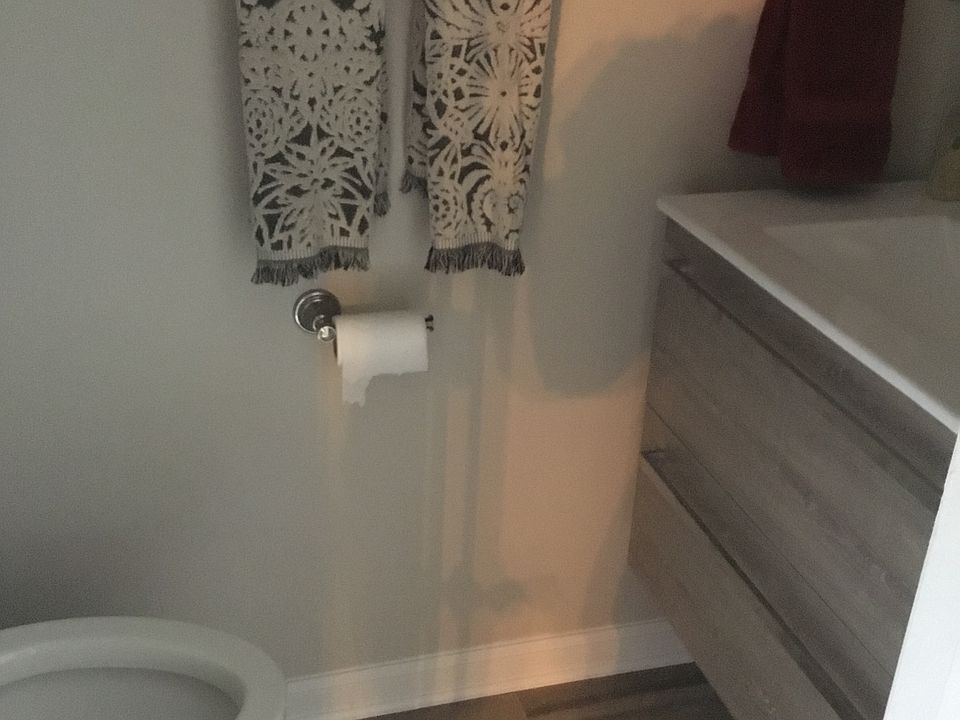 Downstairs half bath. Updated with ceramic til floor and floating vanity.