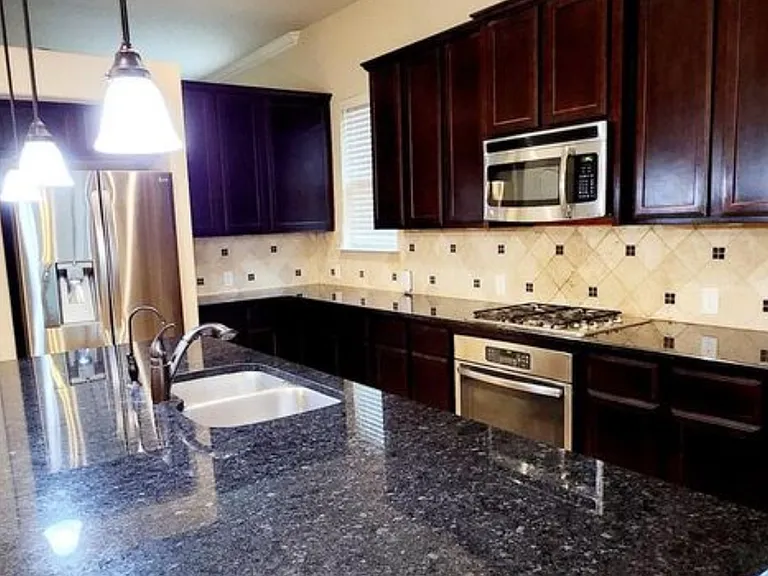 Granite countertops with large cabinets. Over the oven microwave. Dishwasher and refrigerator. Pantry