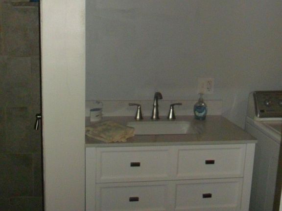 New vanity with drawers and open shelf storage; new lighting