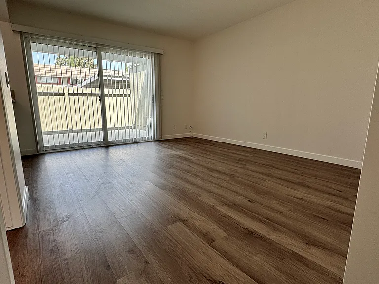 Dining/family room with new vinyl plank flooring, new paint & blinds!