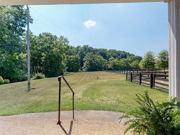 Front porch view of front field with properties creek to the left.