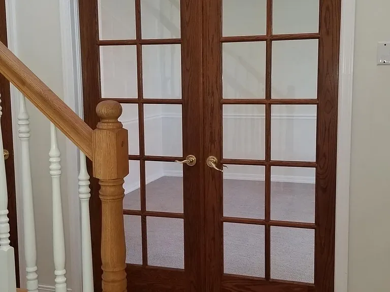 Glass Oak French doors to office or parlor by front entry.