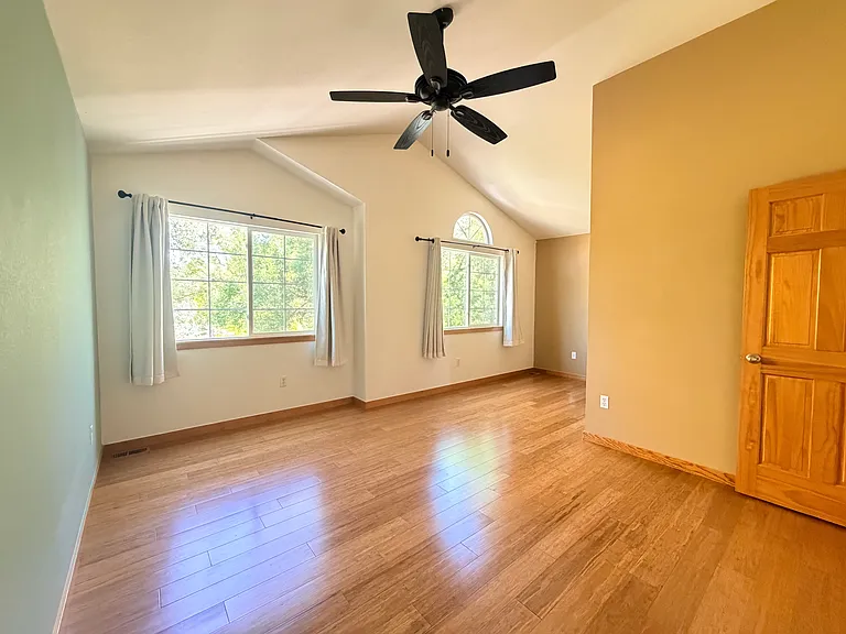 Spacious primary suite with vaulted ceilings and abundant natural light