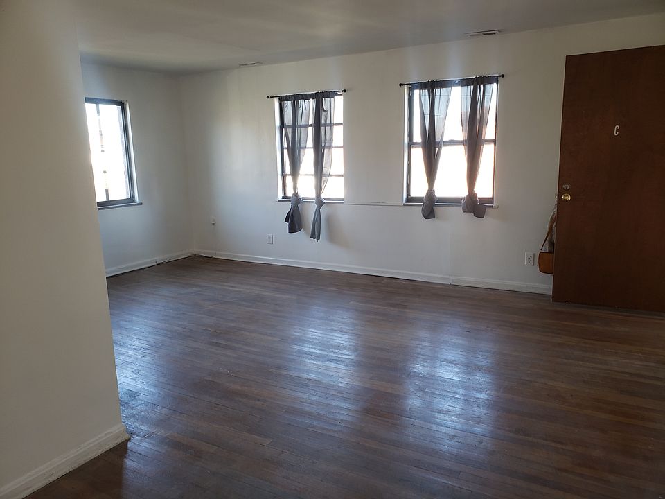 living room with 3 windows and additional space for dinning table