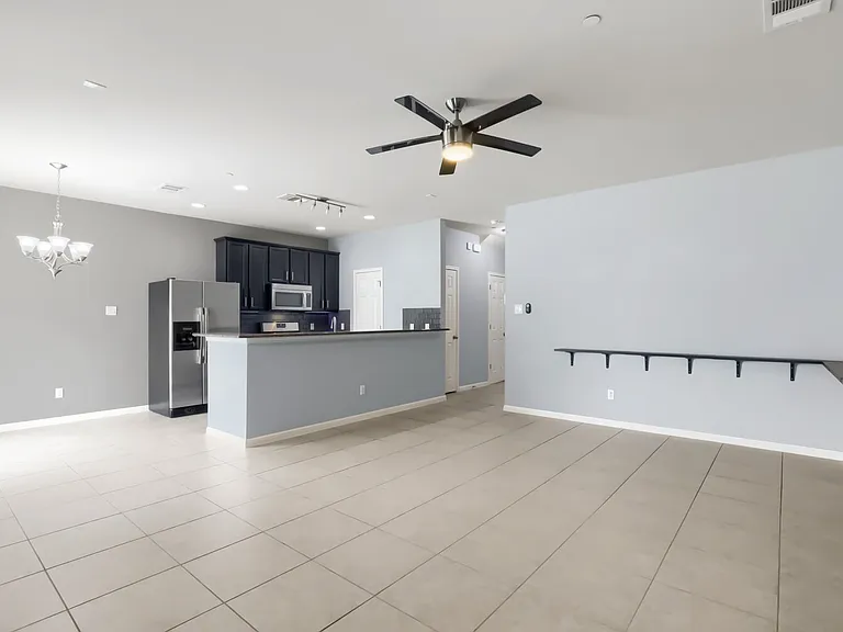 Living room features a wall mounted display ledge for behind the sofa