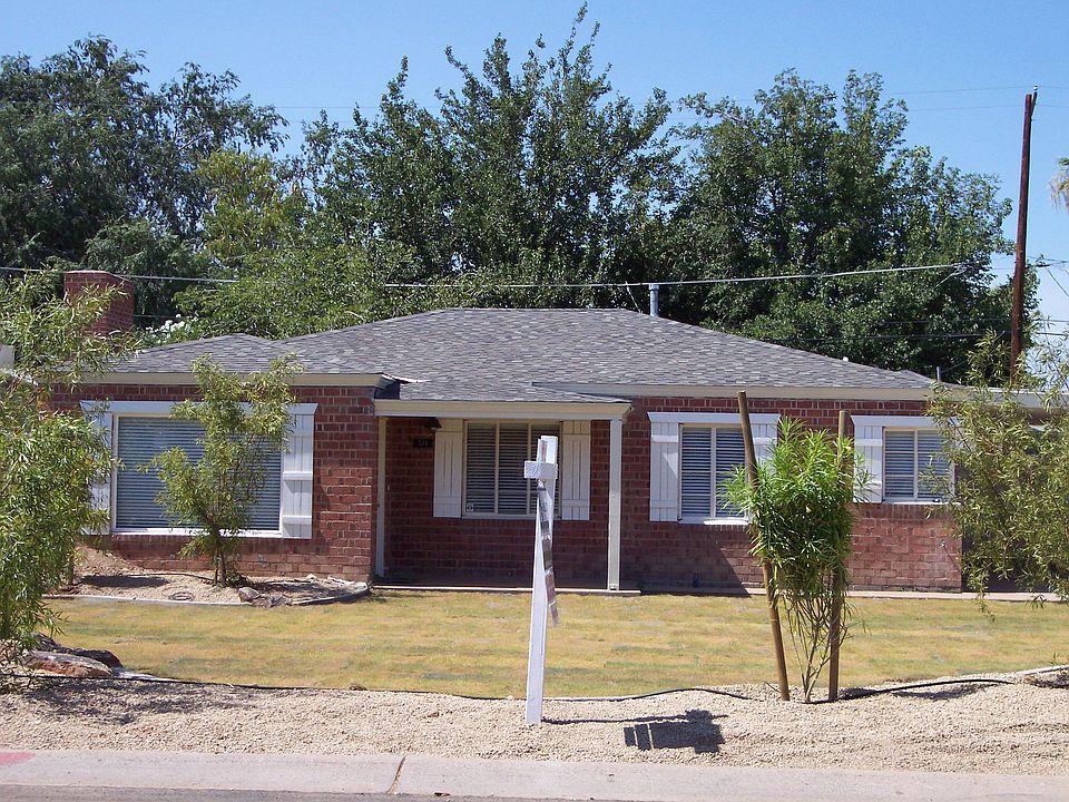 Front of Home with just a few of the many tropical trees showing.