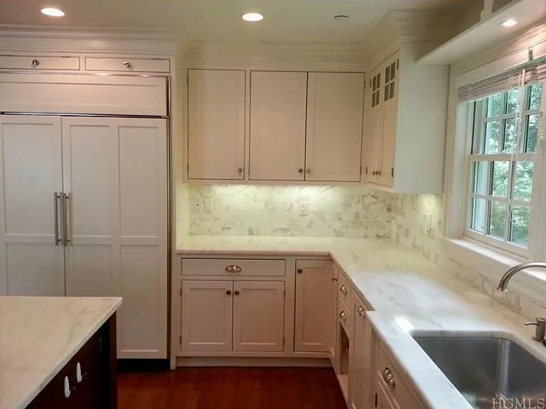 Sub Zero refrigerator. Bosch
dishwasher. Large sink with electric garbage disposal. Pull-out baskets for vegetables. Corner cabinet with turntable.